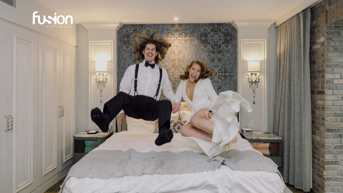 couple jumping on bed