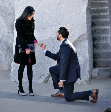men propose to her with ring in black clothes