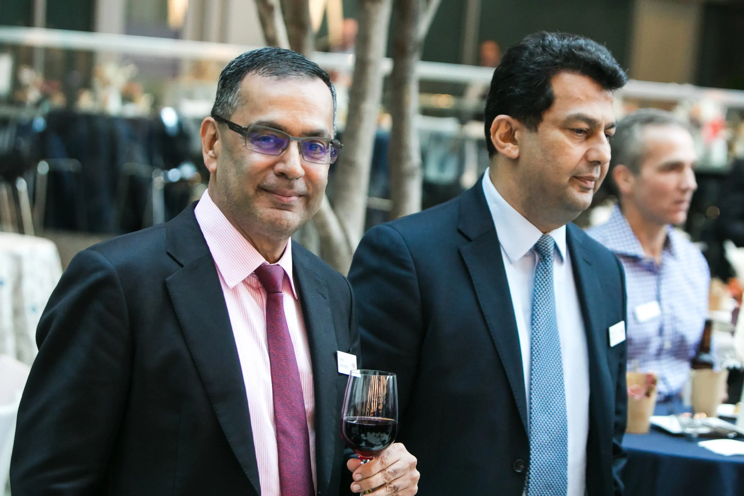 two businessmen with red wine glass