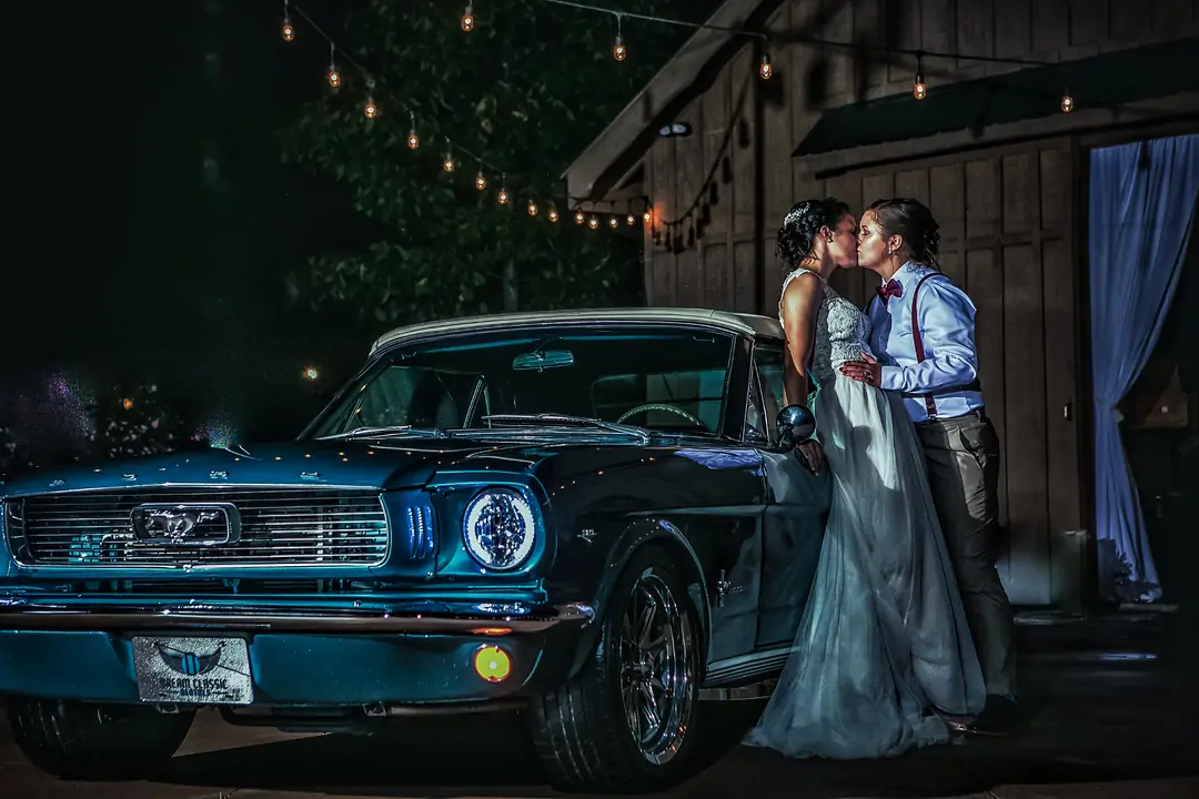 two girls wedding picture with car